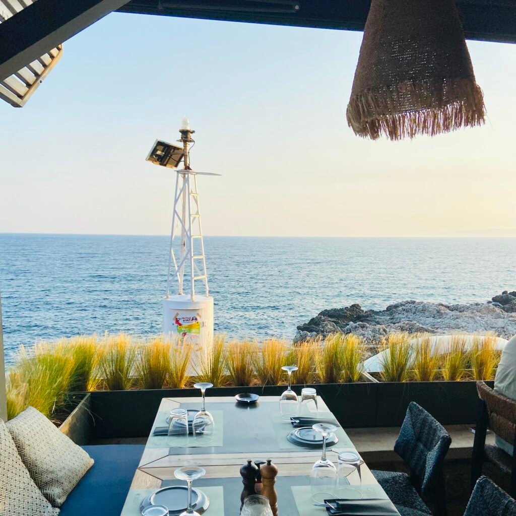 Covered outdoor dinning area with sea view at Tikla Cuzina Kardamili in the Mani Peninsula