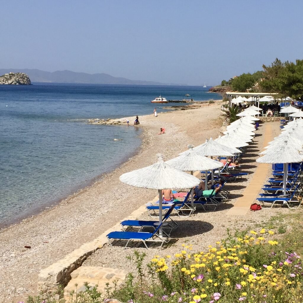 Vlichos Beach organized with umbrellas and sunbeds on the Greek Island of Hydra