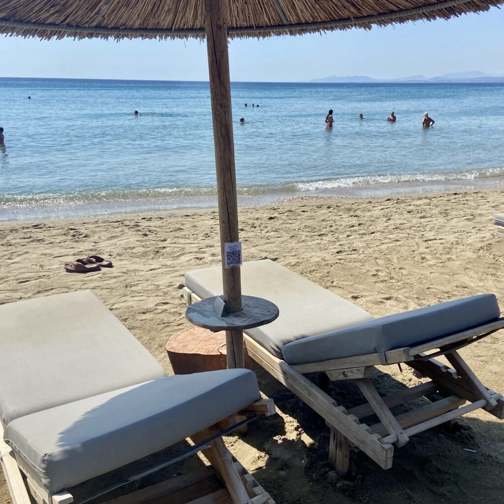 Sunbeds and sea at Delfini Beach Restaurant at Schinias Beach Day Trips from Athens for Families