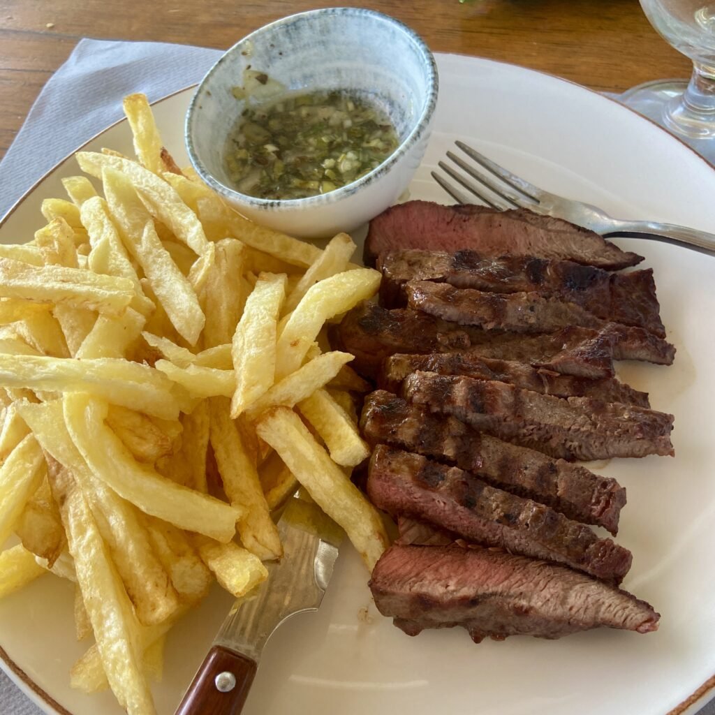 Steak and fries at Delfini Beach Restaurant at Schinias Beach Day Trips from Athens for Families