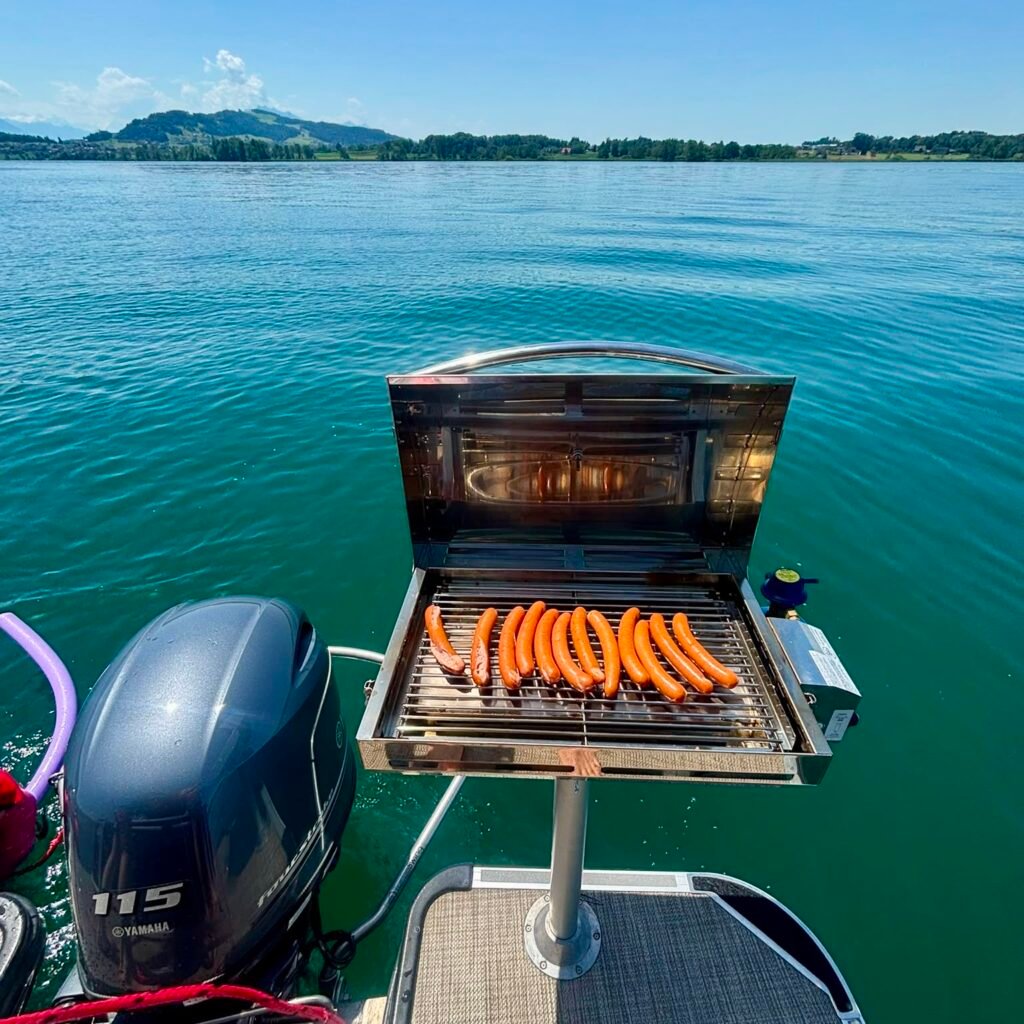 hot dogs on grill Zug Boat Rental on Lake Zug Switzerland Family Day Trip